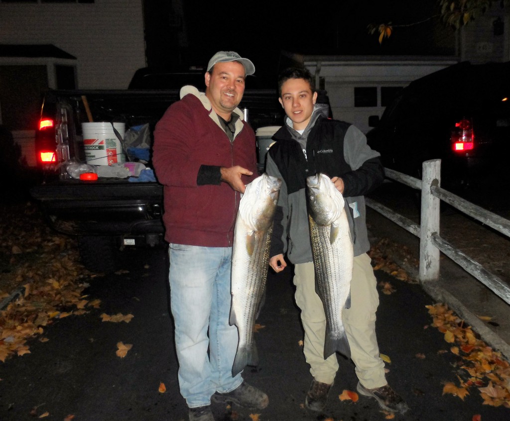 Freddy Fischer holding striped bass he caught