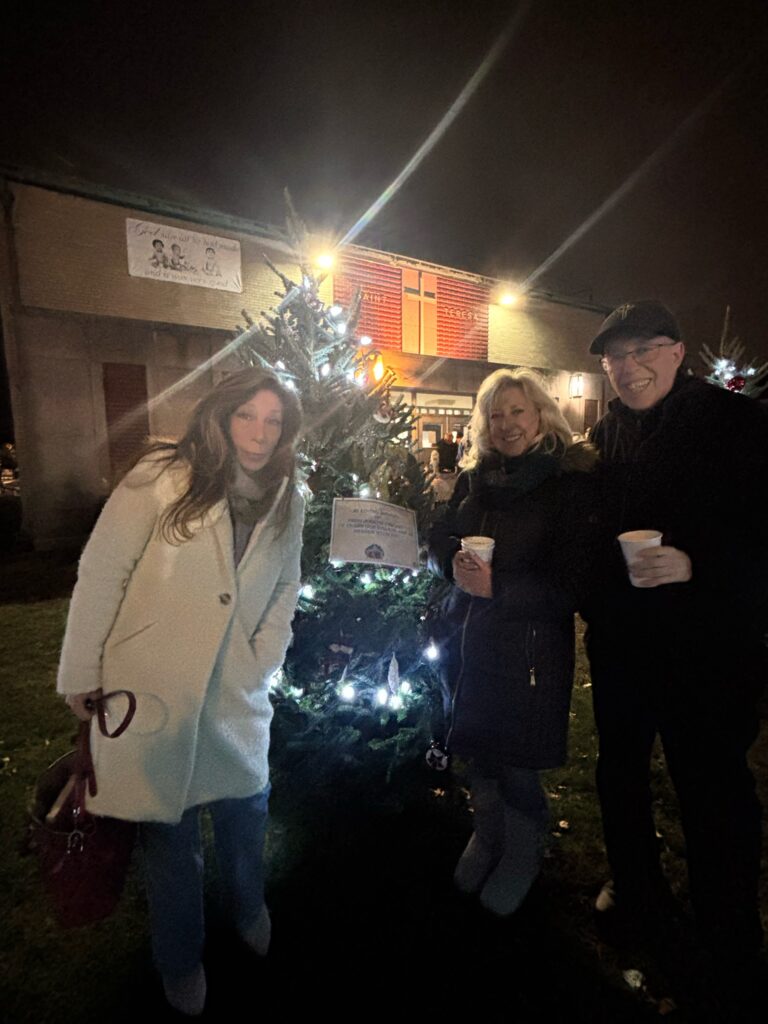 Family and friends at the 2025 St. Teresa tree lighting by Freddy's memorial tree