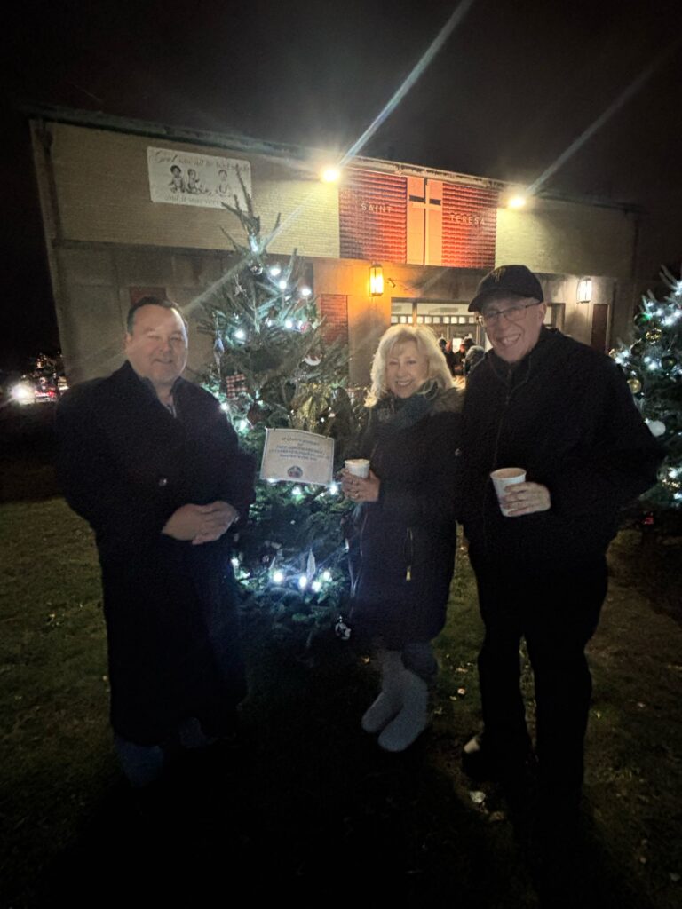 Family and friends at the 2025 St. Teresa tree lighting by Freddy's memorial tree